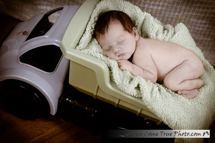 Newborn baby boy in a truck - vintage take of the adorable 1 week old deliciousness